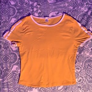 yellow croptop with white designs on the shoulders